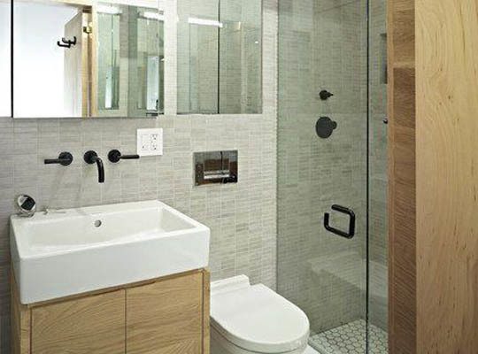 Bathroom with glass shower door, wooden cabinets