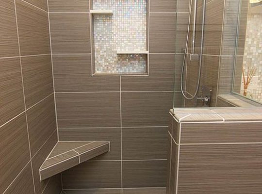 A bathroom design with a shower and a bench, creating a functional space.